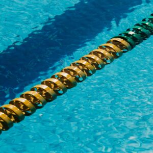 From above of lane marker in rippled blue water in swimming pool on sunny day